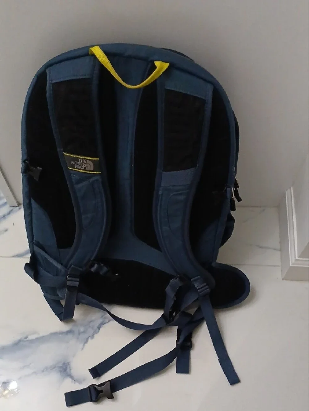 The North Face Navy Blue Backpack with Yellow Accents